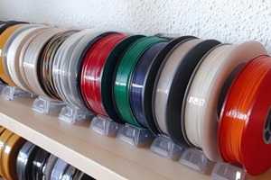 spools of 3D printing motley different colors thermoplastic filament